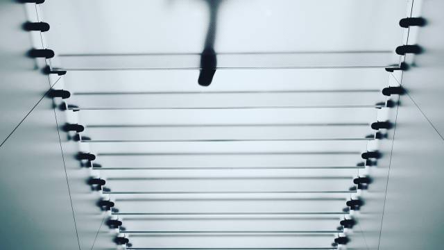 transparent staircase from below with outline of person visible above